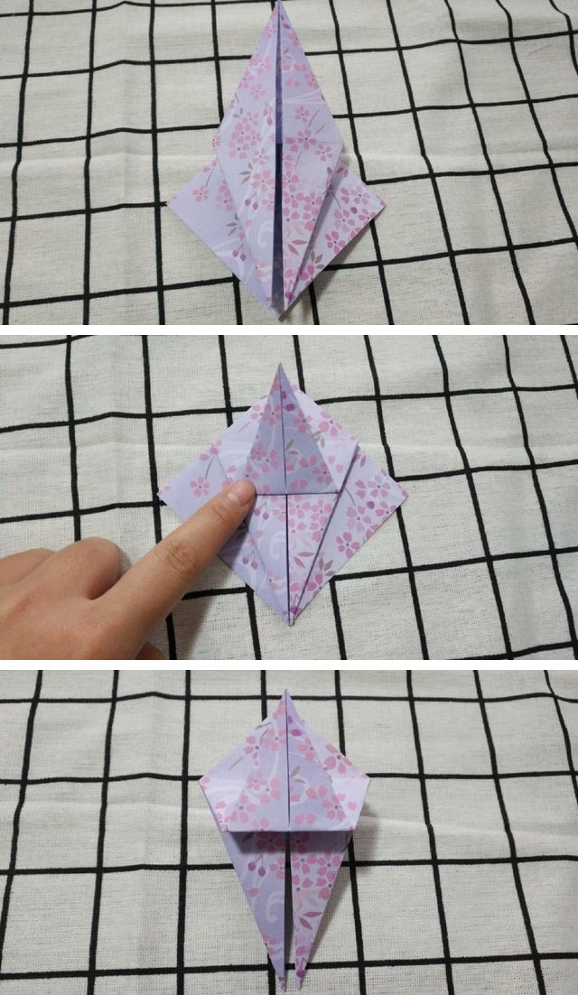 步骤3：2边都对折好了之后，把刚才对折的三角打开，沿着折痕把纸张往里折，折出一个向上的大三角形来，然后把上面的三角往下对折，接着再往上对齐顶端对折，这样中间会对折出一道横向折痕来，同样的折纸步骤把另外一边也折好。