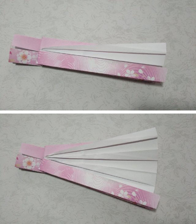 步骤4：2边都对折好了之后，把纸张横向4分之一处对折一道折痕，然后沿着折痕往后折0.5cm左右，然后把下面的白雪公主礼服的裙摆往2边对折