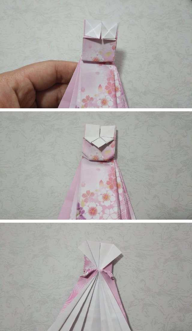 步骤6：连衣裙的裙摆折好后，翻到裙子的正面，上半部分，把里面的纸张像图上一样左右对折，折出三角形来，然后再把2边的纸张往中间对折，对折出2个小三角形来，接着把中间对折出来的三角形折到下面来，这个就是白雪公主礼服连衣裙的上衣折好了，然后再把上衣与裙子连接处2边的小角往里折一点，记住是内折。