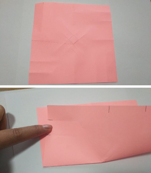 步骤3：然后翻到反面，注意图上我标注的，小正方形的底部顶点连线左边纸张边缘的中间点，这个是对折的折痕，然后把左下角的纸张往上对齐顶端的8分之1处折痕交叉点，底部对齐中间画的连线，最后需要的折痕就是画线的那条。