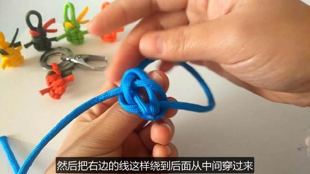 步骤8：然后把右边的圈从后面绕着从中间的孔穿到前面来