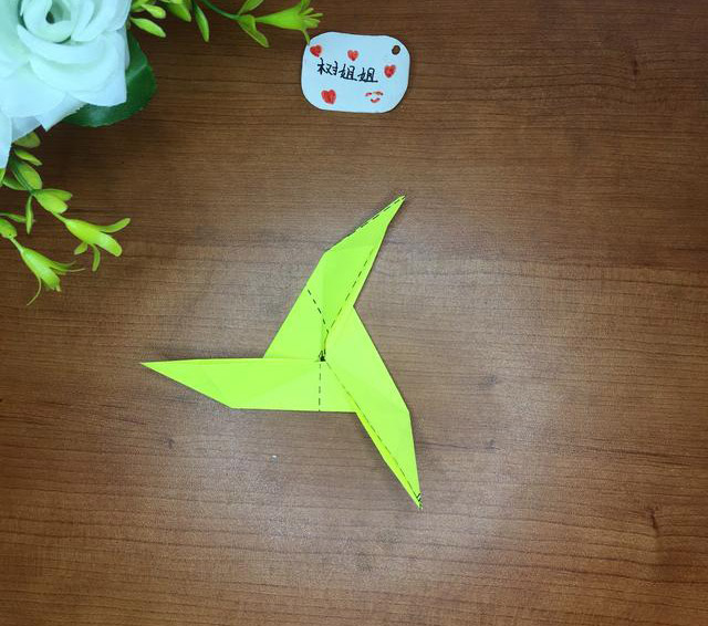 步骤8：将图7中折纸交汇处分别朝顺时针或逆时针方向折压都可以，这样三角飞镖就折出来了。