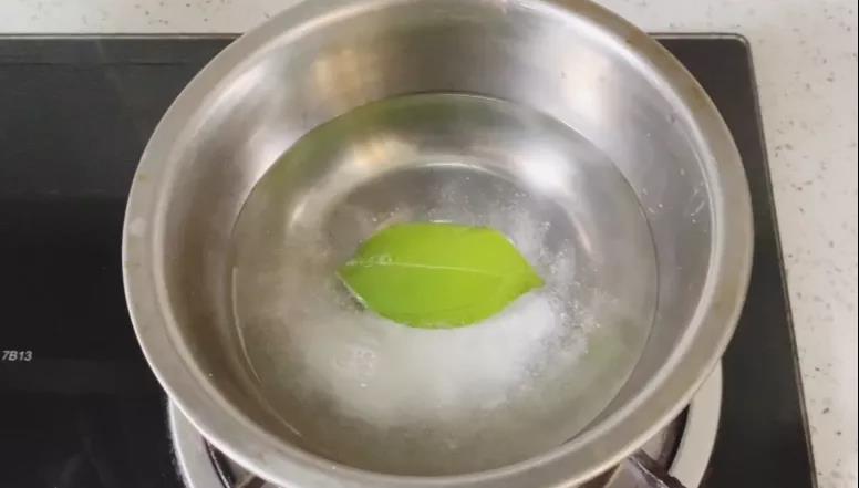 步骤2：锅内加入水，倒入洗衣粉和叶片，水开后转小火煮。