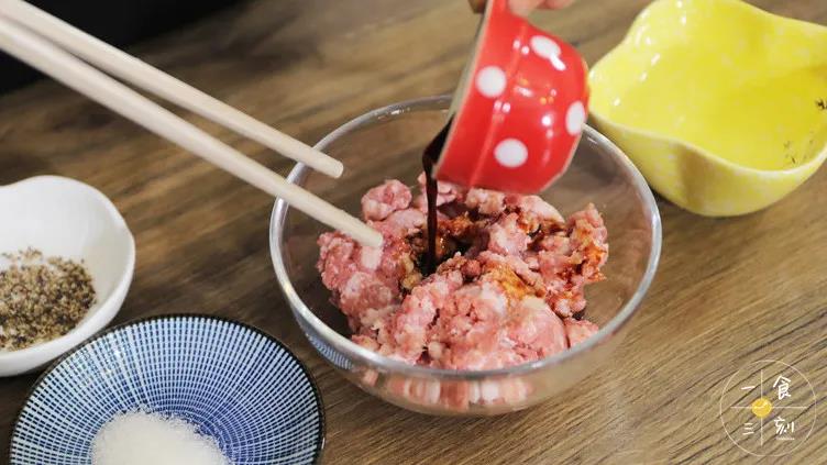 猪肉馅里加入生抽、糖、黑胡椒和少量清水，顺时针搅拌至上劲