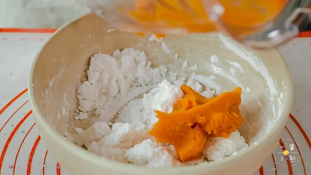 第5步：往大碗里刚烫好的面团中，倒入红薯泥和剩下的另一部分木薯淀粉，用筷子搅拌成絮状