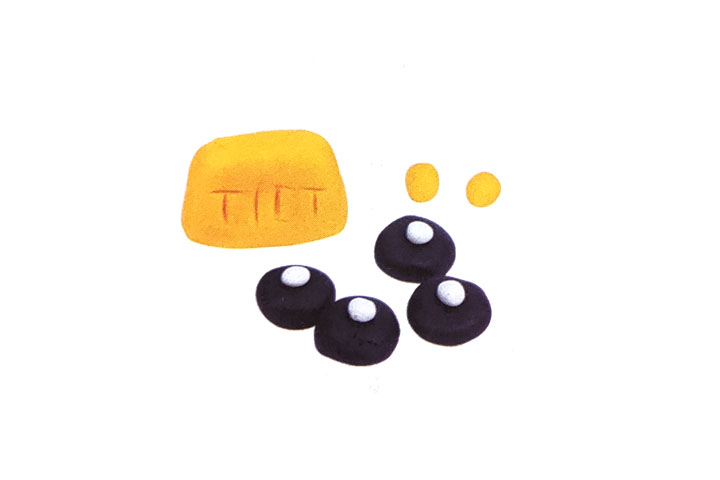 步骤3：用黄泥、白泥和黑泥捏出车灯和车轮。