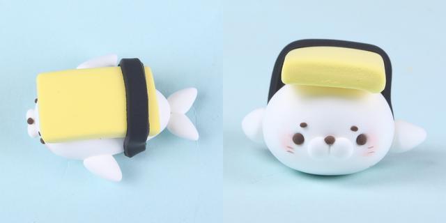 步骤4：黑色粘土做细条缠绕在鱼片和海豹身上，这是海苔。