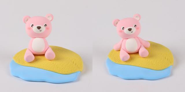 步骤4：把小熊放在做好的沙滩上，然后用粉色粘土做出四肢并做好造型。