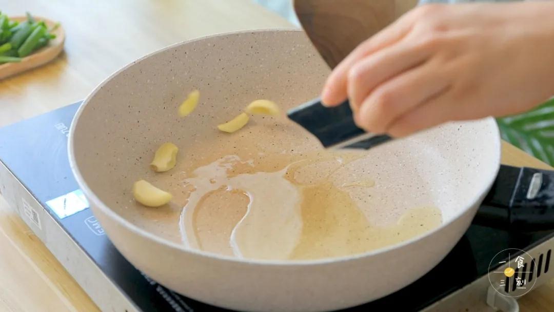 第4步：锅中倒入适量的食用油，加入蒜瓣爆香