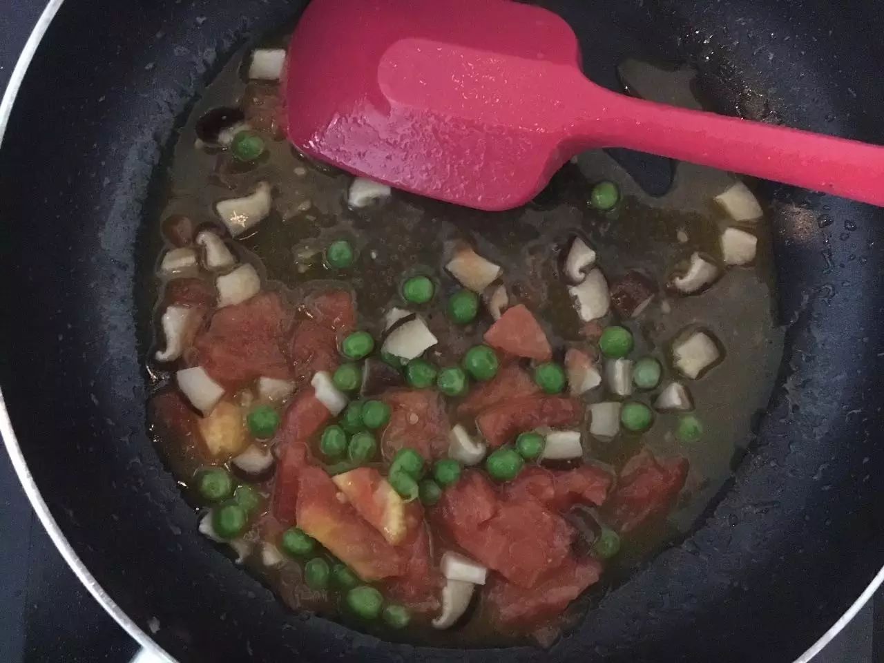 香菇快熟时倒入蕃茄和豌豆。