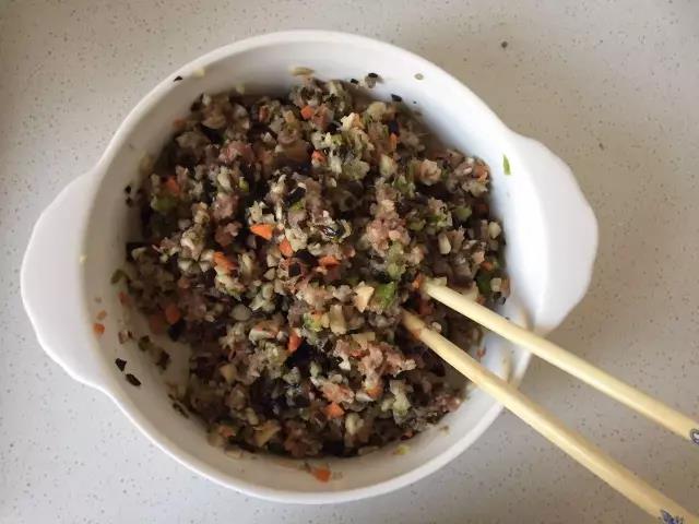 醒面的过程中把蔬菜剁碎，与腌好的里脊肉混合，加入两匙油拌匀。