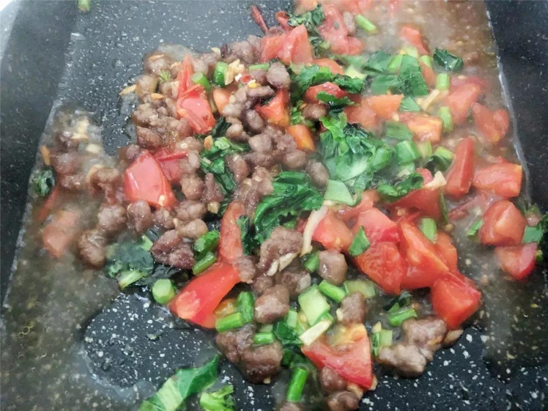 蔬菜炒软后倒入炒好的牛肉，加少许水焖煮片刻。