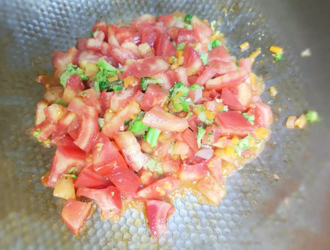 放入西红柿，翻炒至出汁。放入北极贝、贝柱、虾仁、蚬子肉，继续翻炒。