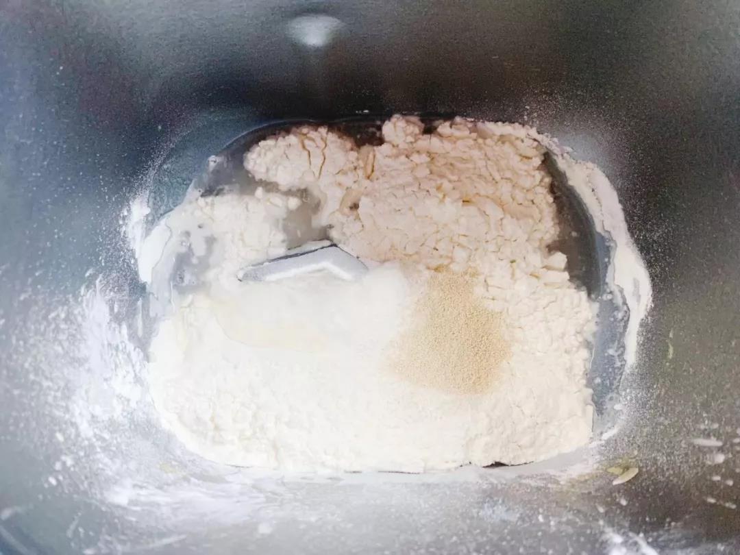 面粉加入温水和酵母，揉成团。