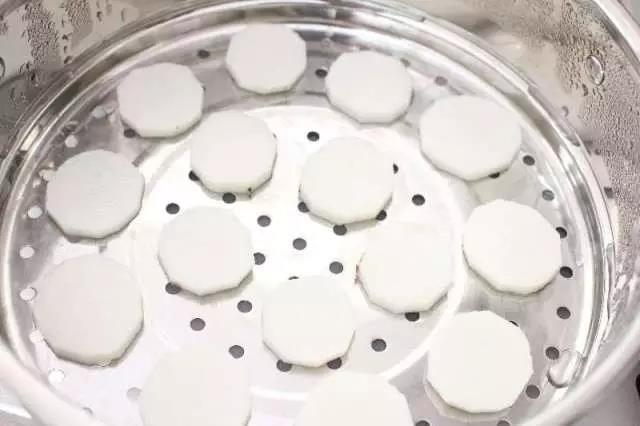 山药去皮切片码放在蒸锅上。