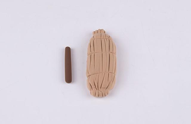 步骤2：先来做插糖葫芦的稻草把。用泥土色做出草把子，并在上面划出稻草的样子，咖啡色粘土揉一根细条做杆子。