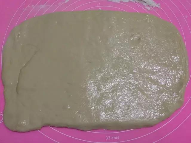 取出面团，擀成面片，在表面刷上一层油。