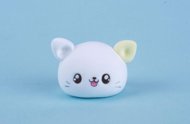 步骤2：用白色粘土做一个椭圆形，然后把耳朵粘在头顶，眼眼睛粘上，最后用彩笔画出鼻子、嘴巴和小猫咪的胡须。