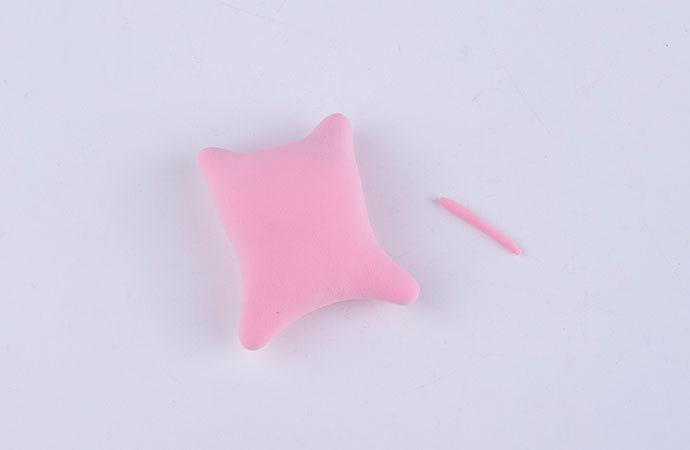 步骤6：开始做小猪的身体啦，用粉红色粘土做一个长方体，然后把四个角捏一下，有点类似于抱枕的形状，不要忘记揉一根小细条来做尾巴。