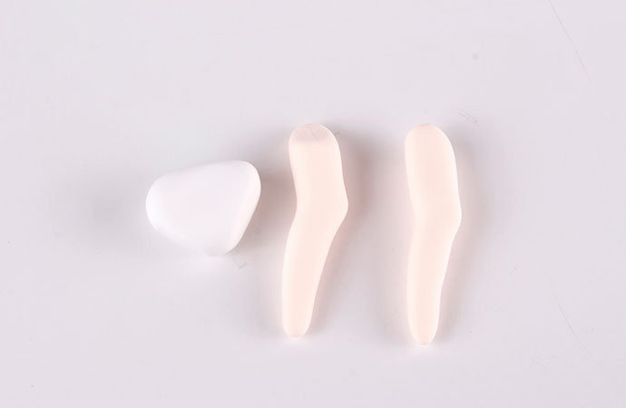 步骤7：白色粘土做一个三角形，肉色粘土做出两条腿。