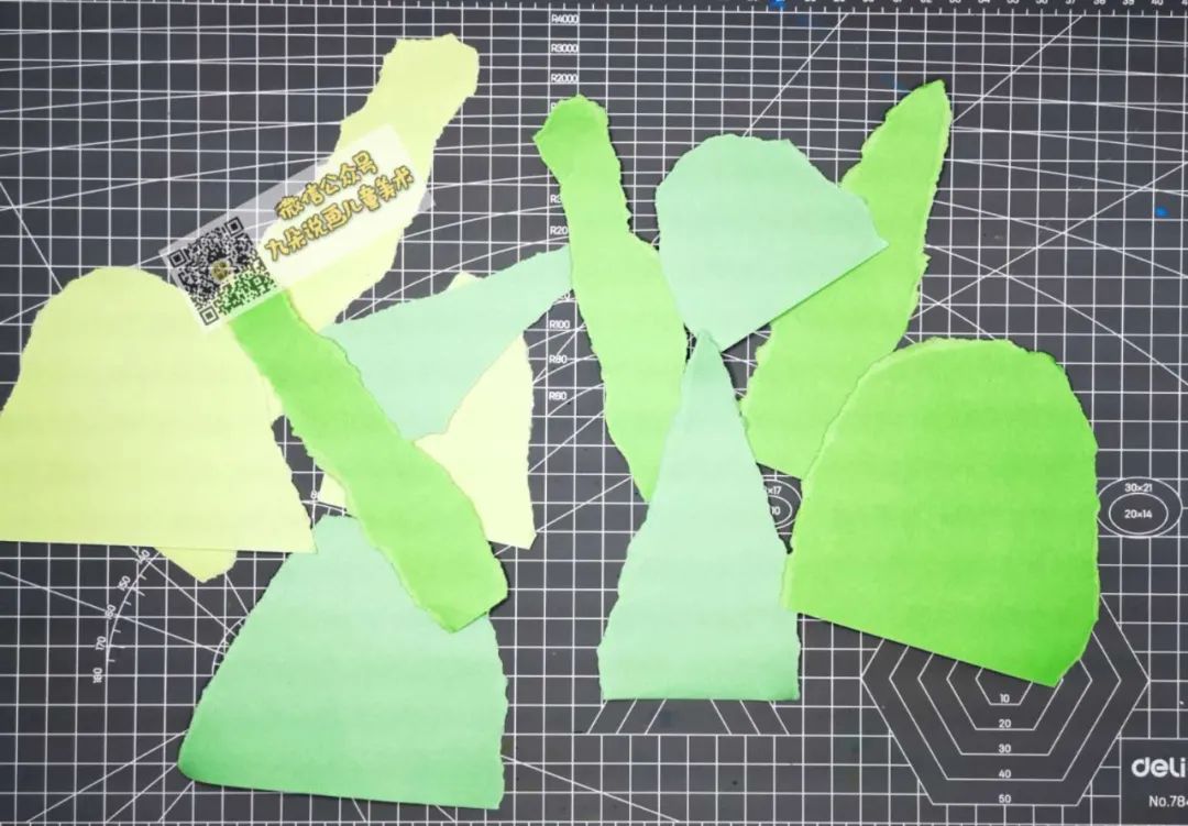 步骤4：准备2-3张绿色的彩纸，手撕成半圆或者长条形状。