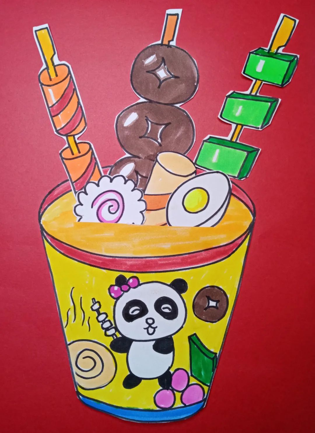 步骤7：将杯子粘在背景的卡纸上，注意杯子的中心不要粘住，把画好的食材插入杯子中。