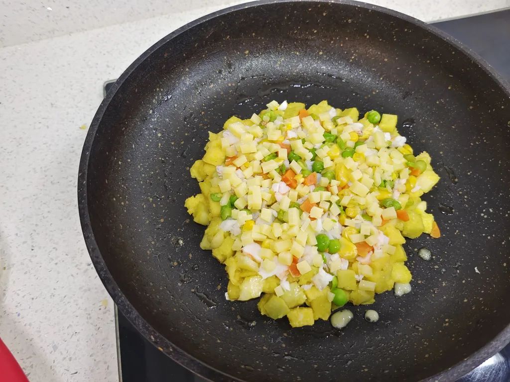 在馒头上均匀铺上虾仁、蔬菜、干酪碎，盖上锅盖小火焖一会儿，至干酪融化、食材全熟。